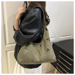 Vue détaillée du sac hobo en daim vert olive avec découpes florales décoratives sur mannequin