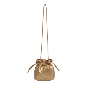 Minimalist golden drawstring bucket bag with a sleek metallic finish and thin shoulder strap