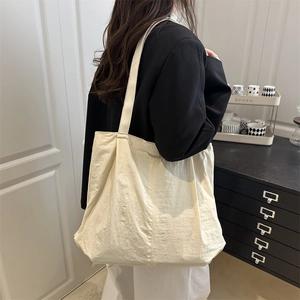 Minimalist off-white high-capacity tote bag with fashion tag for office commute style