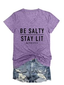 Détail à plat d'un T-shirt violet col en V avec texte et mini-short en jean usé