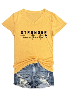 Detail of V-neck t-shirt with Stronger Than The Storm print and ripped denim shorts