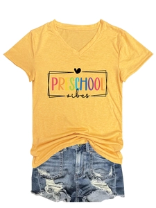 Flat lay of yellow V-neck T-shirt with PRE SCHOOL vibes print and denim shorts