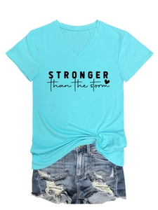Detailed view of V-neck T-shirt with Stronger than the Storm print and denim shorts