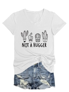 Close-up of Not A Hugger cactus print on a white V-neck T-shirt with denim shorts