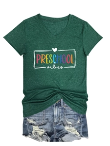 Flat lay of a green V-neck T-shirt with Preschool Vibes print and denim shorts set
