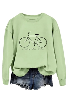 Detail of mint green sweatshirt featuring bicycle print and enjoy the ride slogan