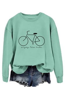 Detail of mint green sweatshirt with bicycle print and enjoy the ride text in casual style