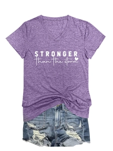 Detail of purple V-neck T-shirt with STRONGER than the storm print and denim shorts