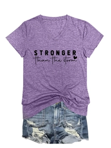 Detail of purple V-neck T-shirt with stronger than the storm text and denim shorts