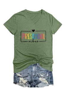 Close-up of Preschool Vibes print on a green V-neck T-shirt with denim shorts