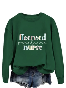 Detail of Licensed Practical Nurse text print on dark green crewneck sweatshirt with shorts