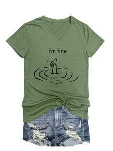 Detail of the 'i'm fine' graphic print on a V-neck army green T-shirt with denim shorts