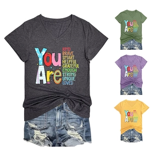 Detail of V-neck cotton T-shirts with Kind Brave Smart lettering in multiple colors