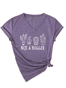 Detail view of V-neck T-shirt showing cactus print and Not a Hugger slogan with hem knot