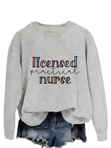 Flat lay of gray sweatshirt with licensed practical nurse print and denim shorts