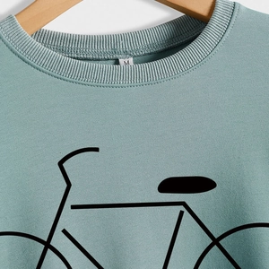 Light green crewneck sweatshirt featuring a black minimalist bicycle print on the chest