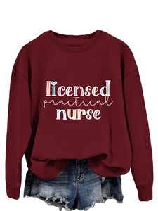 Detail of burgundy sweatshirt featuring Licensed Practical Nurse print with ribbed cuffs