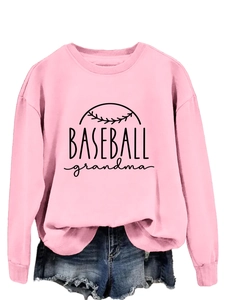 Detailed close-up of pink crewneck sweatshirt with Baseball Grandma print and denim shorts