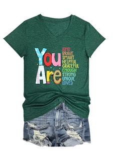 Detail of dark green V-neck T-shirt with inspirational typography and ripped denim shorts