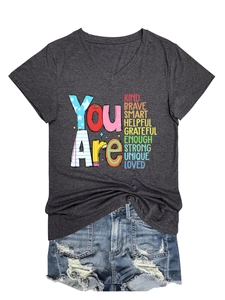 Detail of V-neck grey t-shirt featuring colorful positive text print and fabric texture