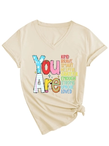 Close-up of beige V-neck T-shirt featuring 'You Are Kind Brave Smart' colorful print
