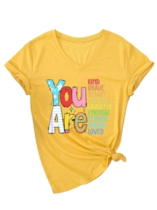 Detail of V-neck yellow T-shirt featuring inspirational text print and stylish front knot