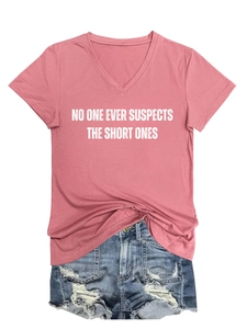 Detail of pink V-neck T-shirt with white text and distressed denim shorts with frayed hems