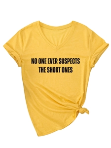 Detail of yellow V-neck t-shirt with black graphic text and stylish front hem knot