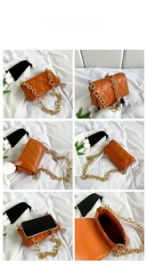 Detail view of orange quilted crossbody bag with chunky gold chain strap and interior