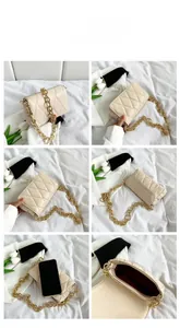 Detail view of cream quilted crossbody bag with chunky gold chain strap and phone size reference
