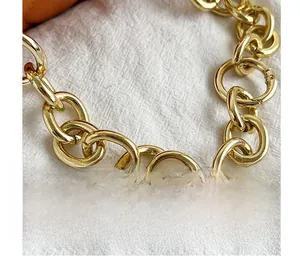 Detailed view of heavy gold-tone metal chain strap with snap hooks for handbags