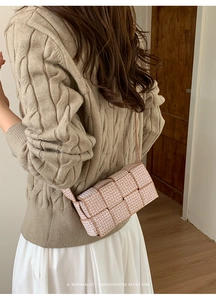 Detail of woven square shoulder bag with retro pattern worn by a model in casual outfit