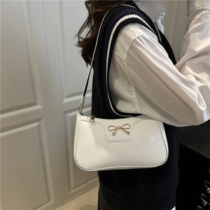 Chic white glossy patent leather underarm bag with a golden bow for women's fashion