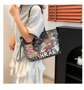 Detail of a black tote bag featuring colorful retro graffiti and cartoon bear patterns