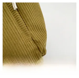 Detailed close-up of premium olive corduroy fabric texture with white cotton drawstring