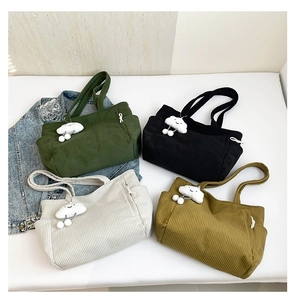 Corduroy tote bags in four colors with cute cloud pendants and striped texture detail