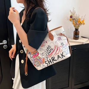 Stylish white tote bag with colorful cartoon graffiti and brown leather handles