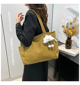 Corduroy tote bag in mustard yellow featuring a cute white cloud plush charm detail