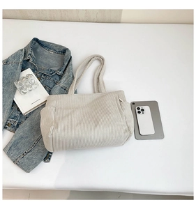 Flat lay of beige corduroy tote bag showing striped texture and spacious storage capacity