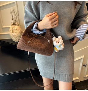 Brown leopard print suede bag with a bow tie and cute white plush bear keychain charm