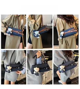 Denim shoulder bag with leather straps and bear pendant shown on model in various angles