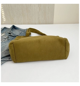 Detail of mustard yellow corduroy tote bag showing vertical ribbed texture and soft fabric