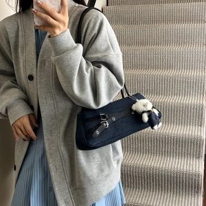 Retro denim underarm bag with black leather straps and plush bear charm decoration