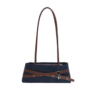 Blue denim shoulder bag with brown leather straps and vintage metallic buckle detail