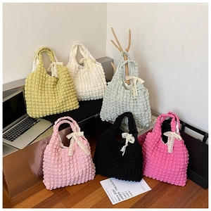 Detail showing colorful popcorn texture tote bags with elegant white lace bow accents