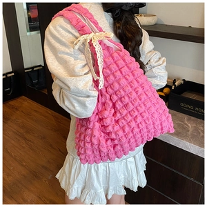 Detailed shoulder view of pink bubble textured tote bag with delicate lace bow decoration