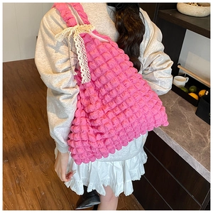 Detailed view of pink pleated cloud bag with elegant white lace bow decoration