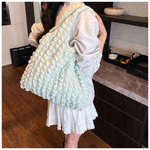 Detail of mint green popcorn texture tote bag showing its unique ruffled fabric surface