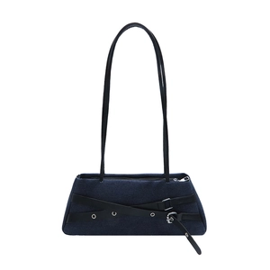 Minimalist navy denim baguette shoulder bag with black leather straps and silver eyelets