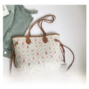 Detail view of cartoon print tote bag set with matching mini pouch and leather strap